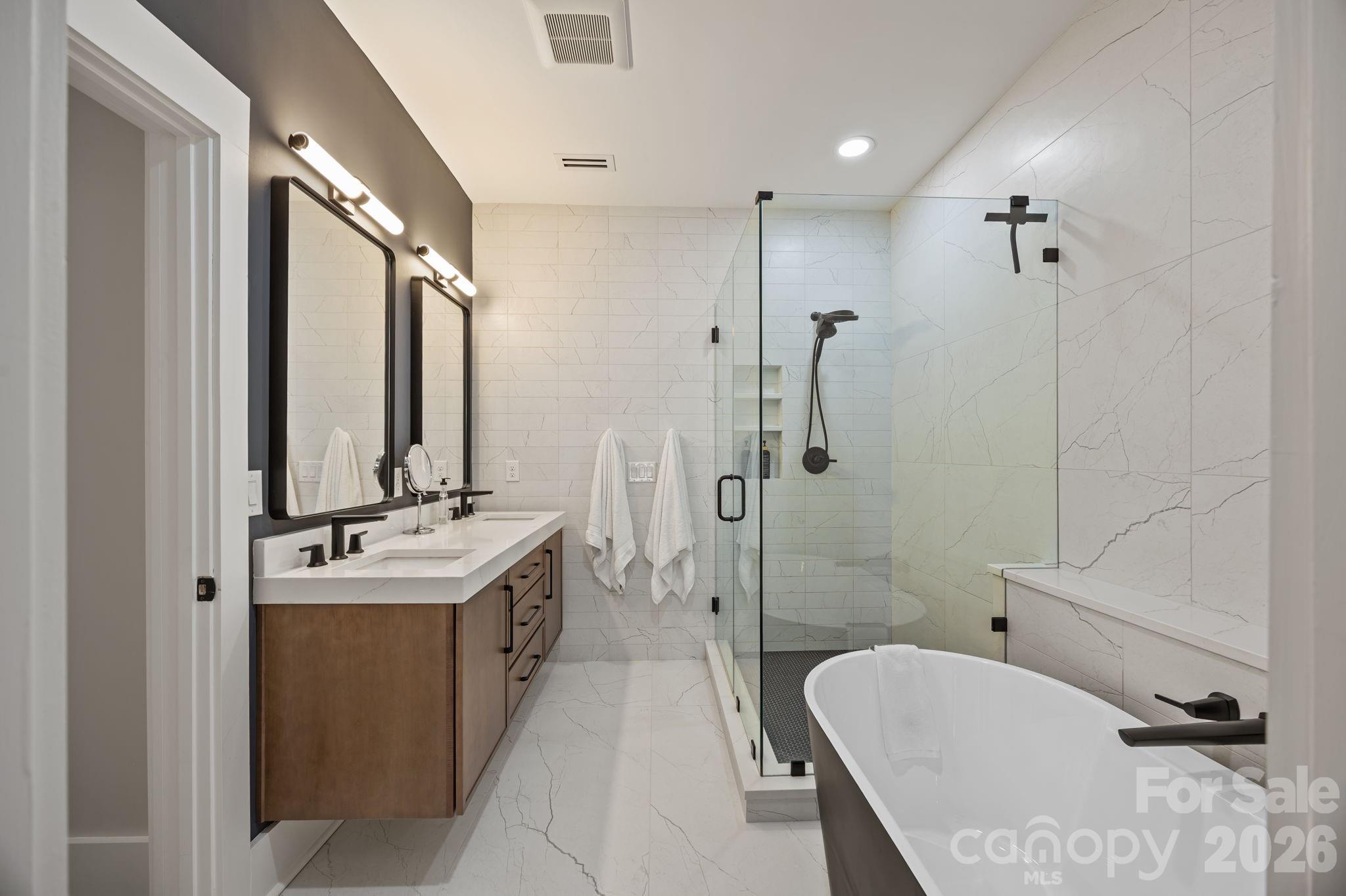 241 North Faulkner Way Davidson, NC 28036 - Photo 22 of 39 a bathroom with a double vanity sink toilet mirror and bathtub
