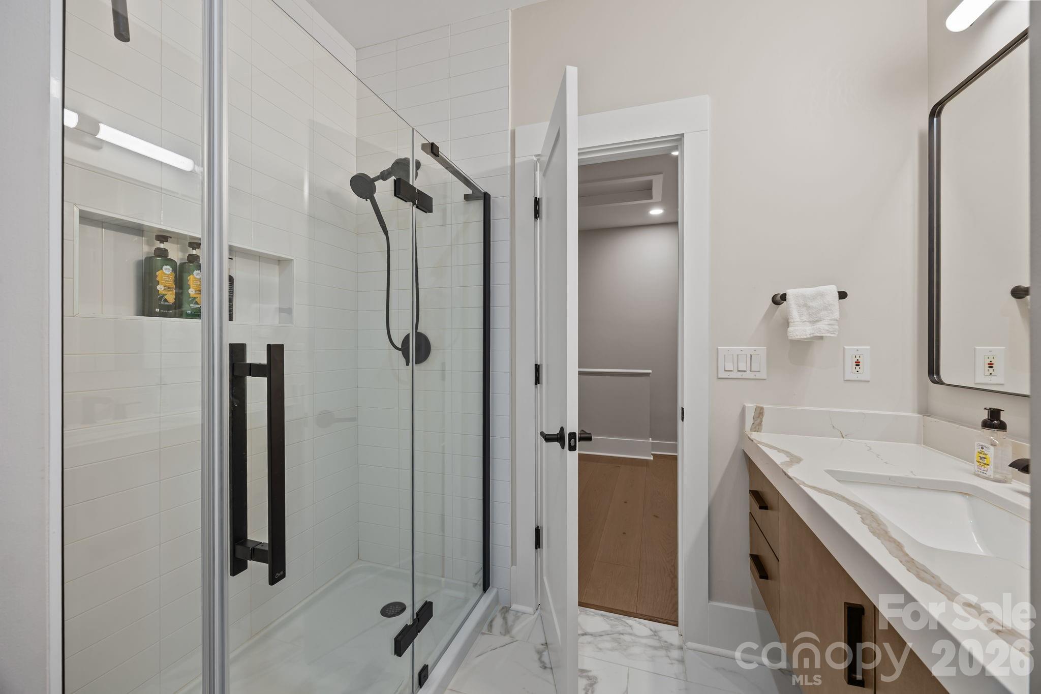 241 North Faulkner Way Davidson, NC 28036 - Photo 29 of 39 a bathroom with a tub sink shower and mirror