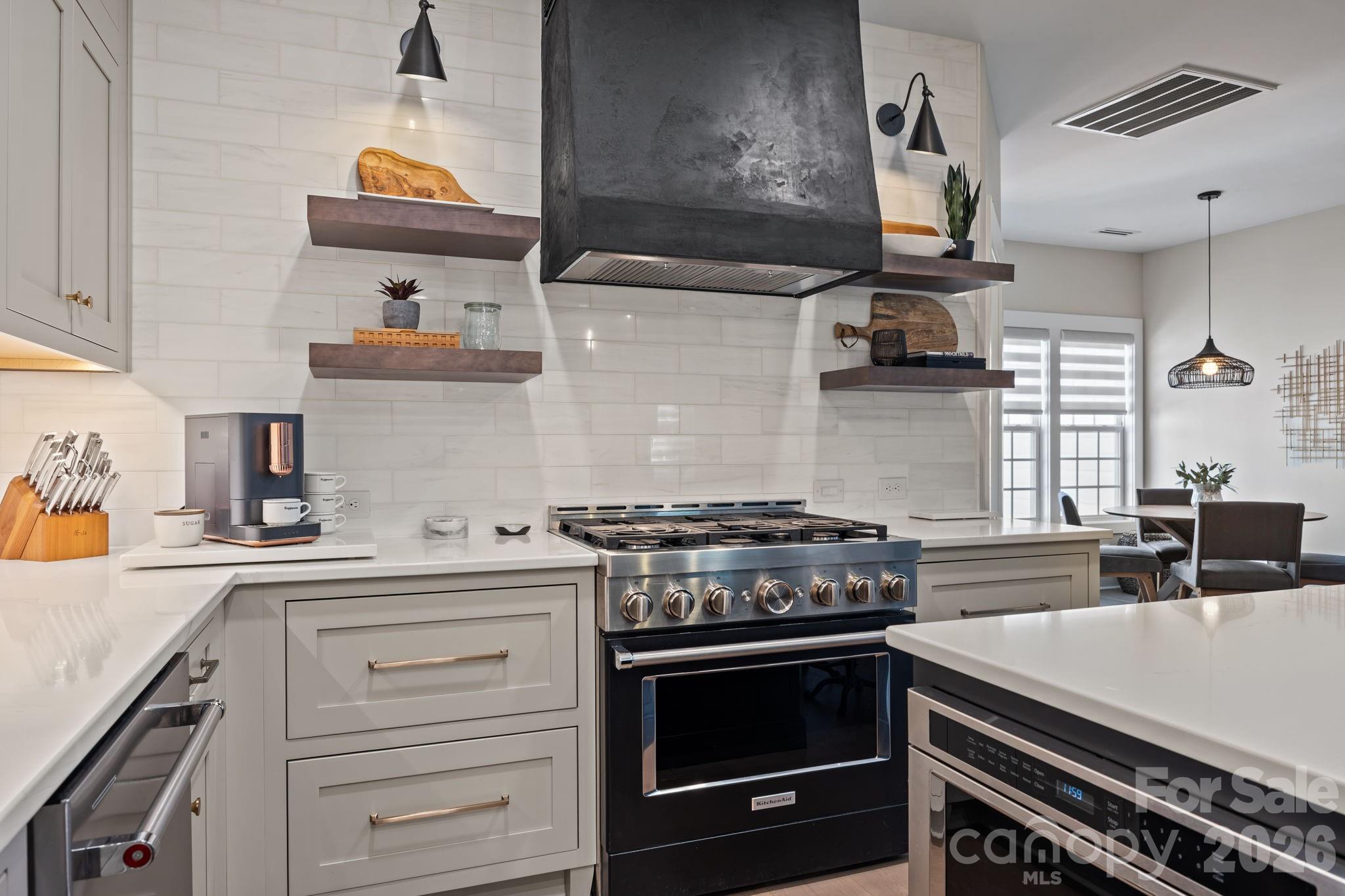 241 North Faulkner Way Davidson, NC 28036 - Photo 3 of 39 a kitchen with stainless steel appliances a sink stove and cabinets