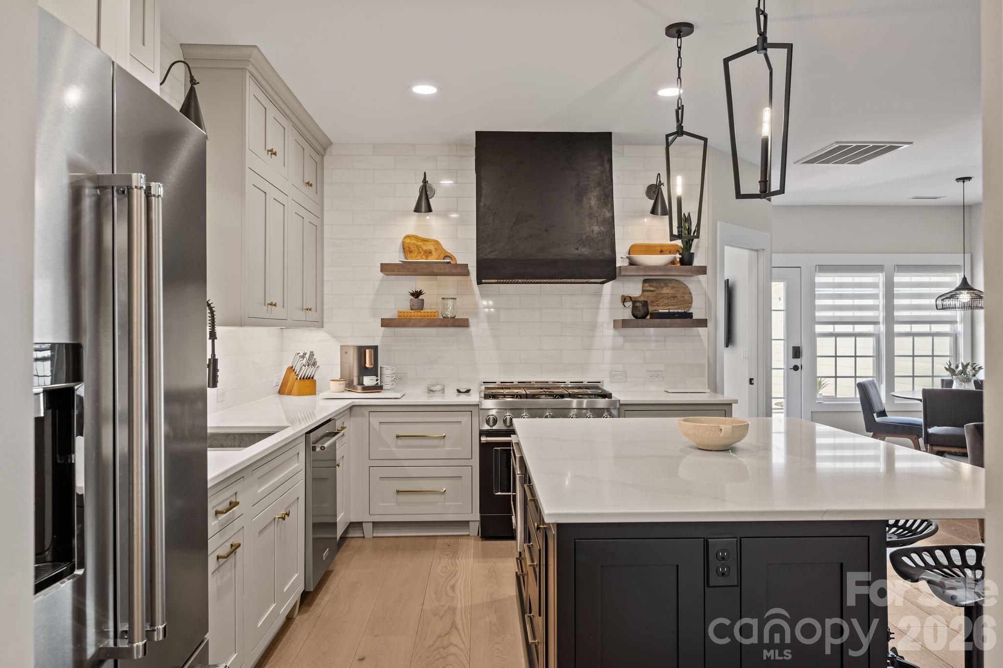 241 North Faulkner Way Davidson, NC 28036 - Photo 7 of 39 a kitchen with stainless steel appliances a sink stove and refrigerator
