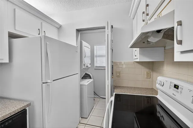 a kitchen with stainless steel appliances a refrigerator and a stove