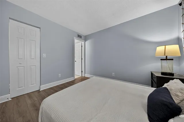 a bedroom with a bed and a lamp