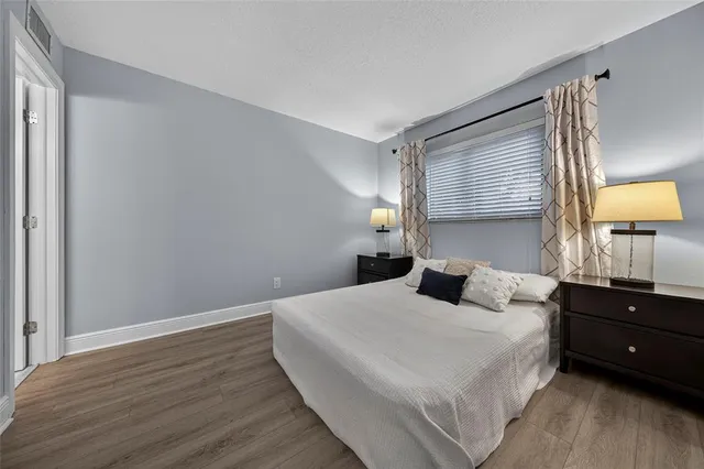 a bedroom with a bed and a lamp