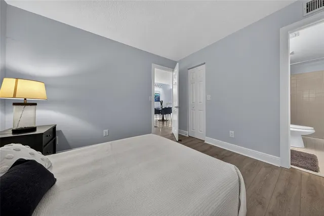 a bedroom with a bed and a lamp