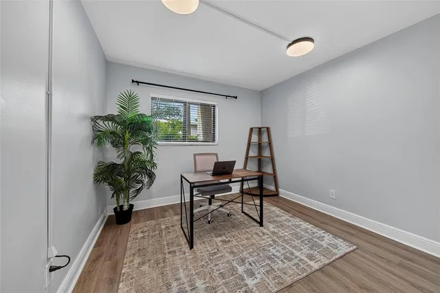 a work room with furniture and a potted plant