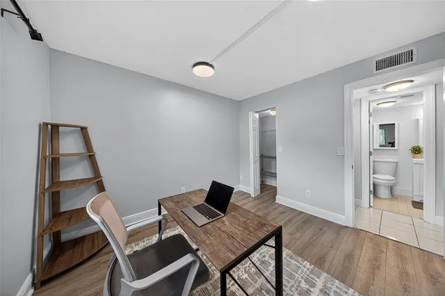 a workspace with furniture and view of bathroom