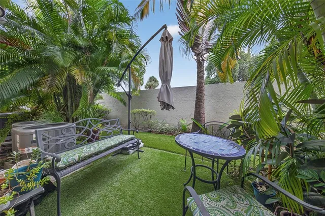 a view of a chairs and table in backyard
