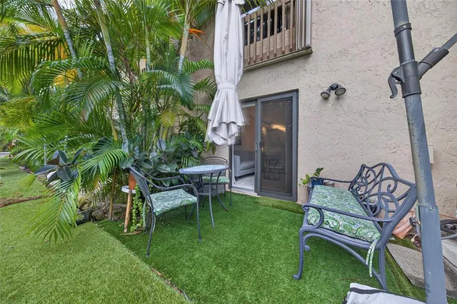 a backyard of a house with table and chairs