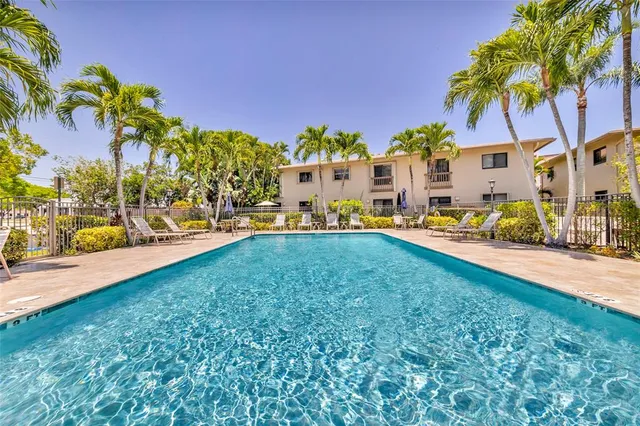 a front view of a house with a yard and lake view