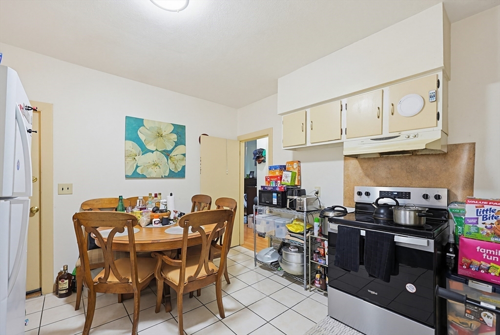 15 Kenneson Road Somerville, MA 02145 - Photo 4 of 18 a view of a dining room with furniture and a kitchen