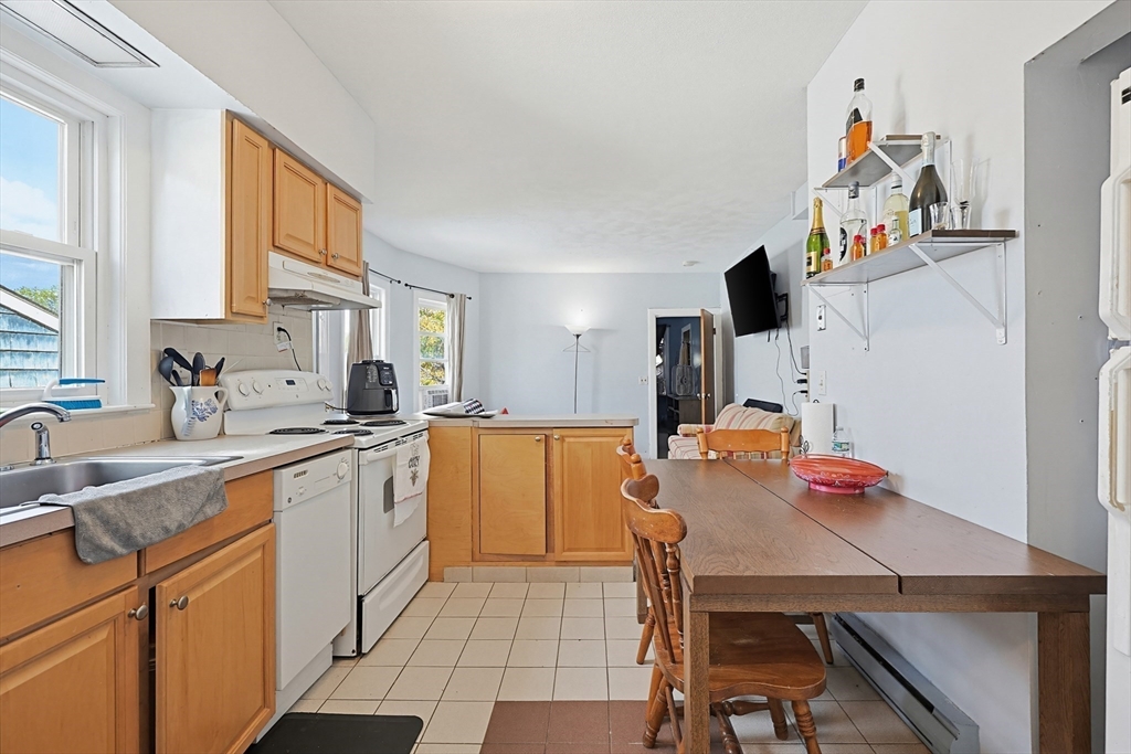15 Kenneson Road Somerville, MA 02145 - Photo 9 of 18 a large kitchen with a table and chairs in it