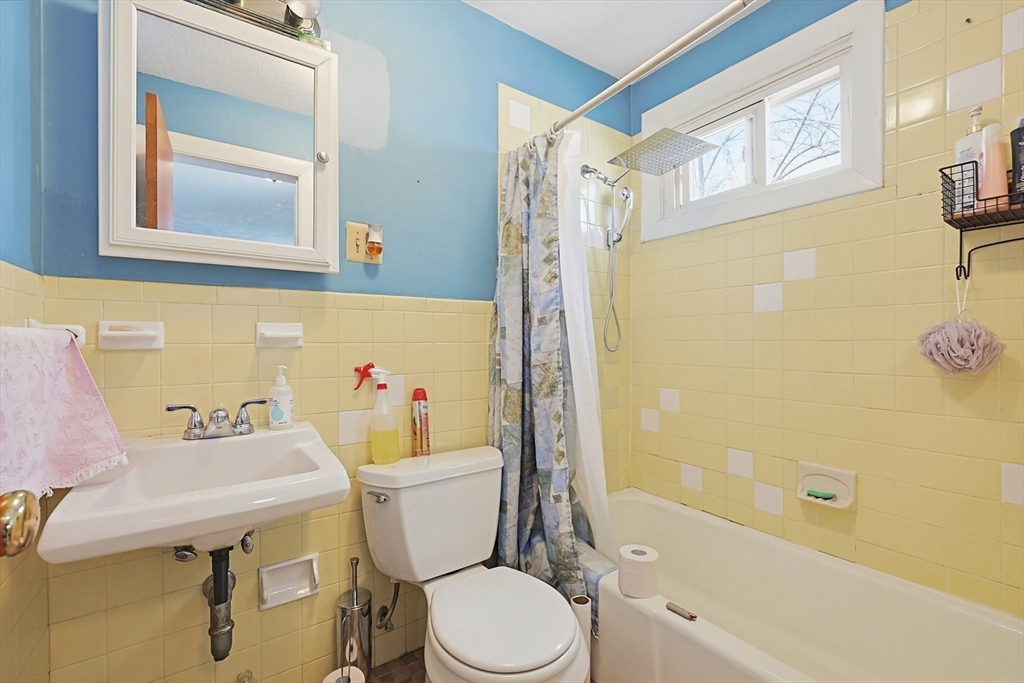 15 Kenneson Road Somerville, MA 02145 - Photo 10 of 18 a white toilet sitting next to a bathroom sink