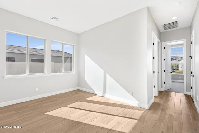 a view of a hallway with wooden floor and entryway