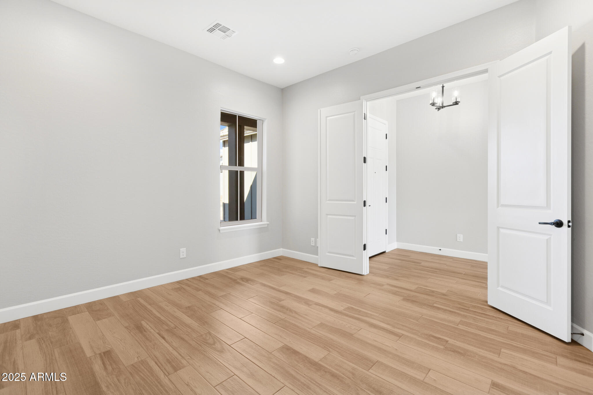953 Ridge Road Apache Junction, AZ 85120 - Photo 16 of 18 a view of an empty room with wooden floor and a window