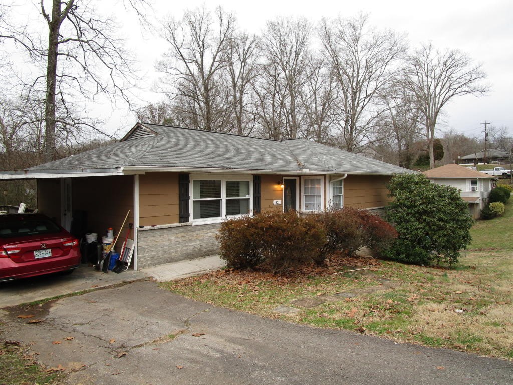 303 Walnut Valley Road Clinton, TN 37716 - Photo 19 of 19 a front view of a house with a yard and garage