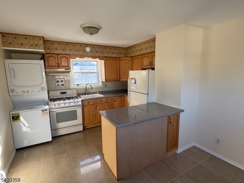 119 Church Street Lodi, NJ 07644 - Photo 7 of 8 a kitchen with a stove and a refrigerator