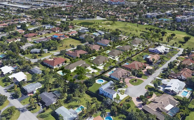 an aerial view of residential houses with outdoor space