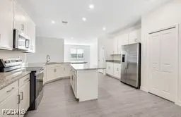 a kitchen with refrigerator and cabinets