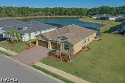 an aerial view of a house with outdoor space and lake view