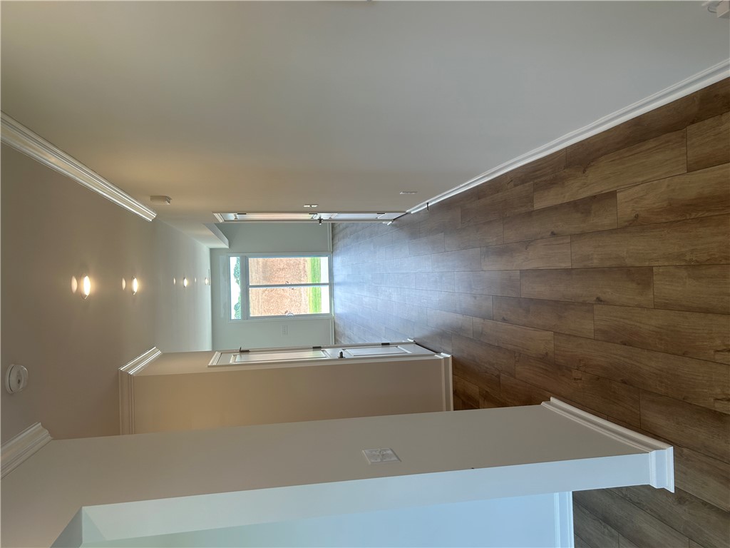 217 Bellflower Lane Anderson, SC 29625 - Photo 4 of 27 Rich hardwood-style flooring extends through this well-lit hallway with architectural crown molding.