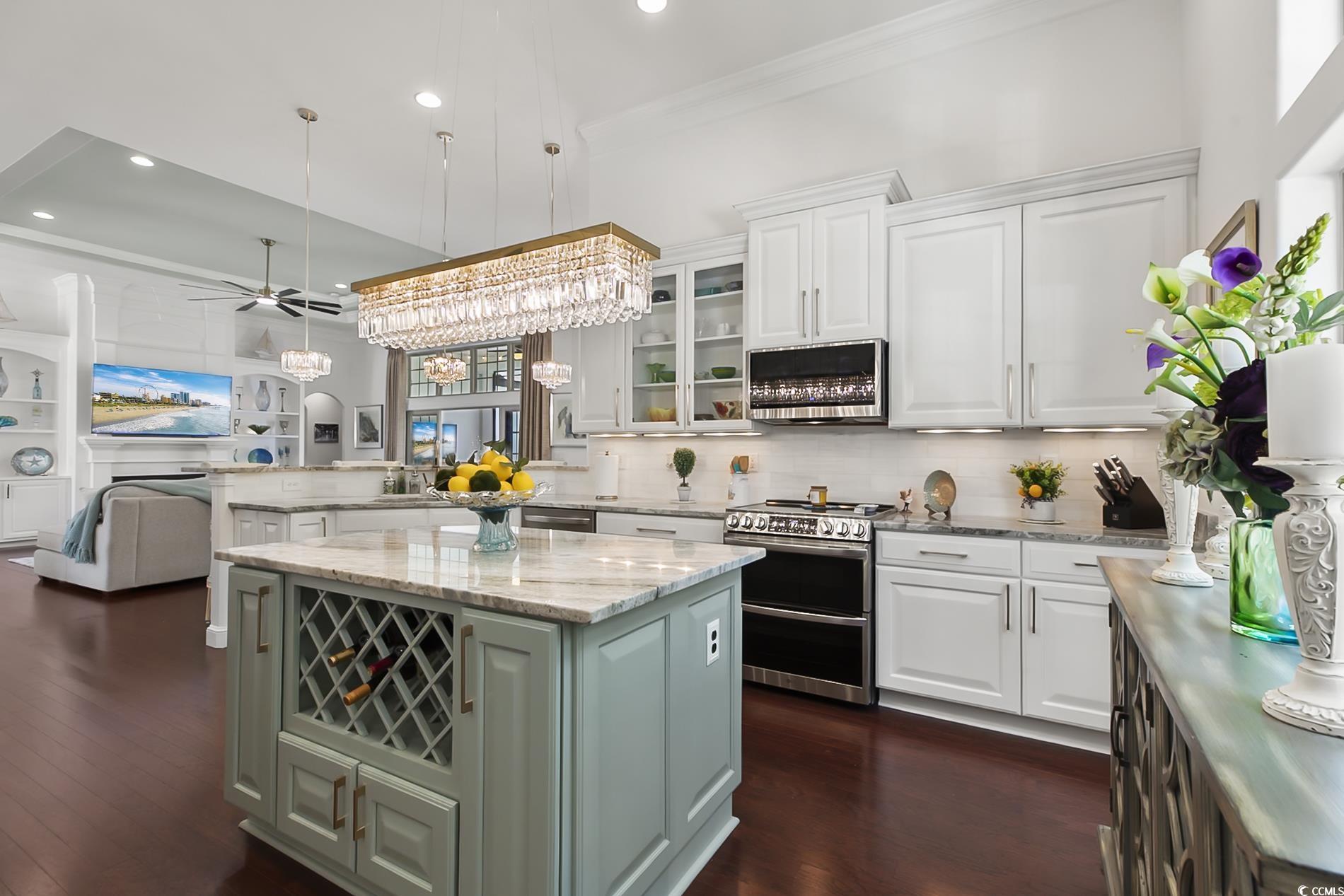 4000 Girvan Drive Myrtle Beach, SC 29579 - Photo 38 of 40 Kitchen with open floor plan, stainless steel appliances, light stone counters, a ceiling fan, and white cabinets