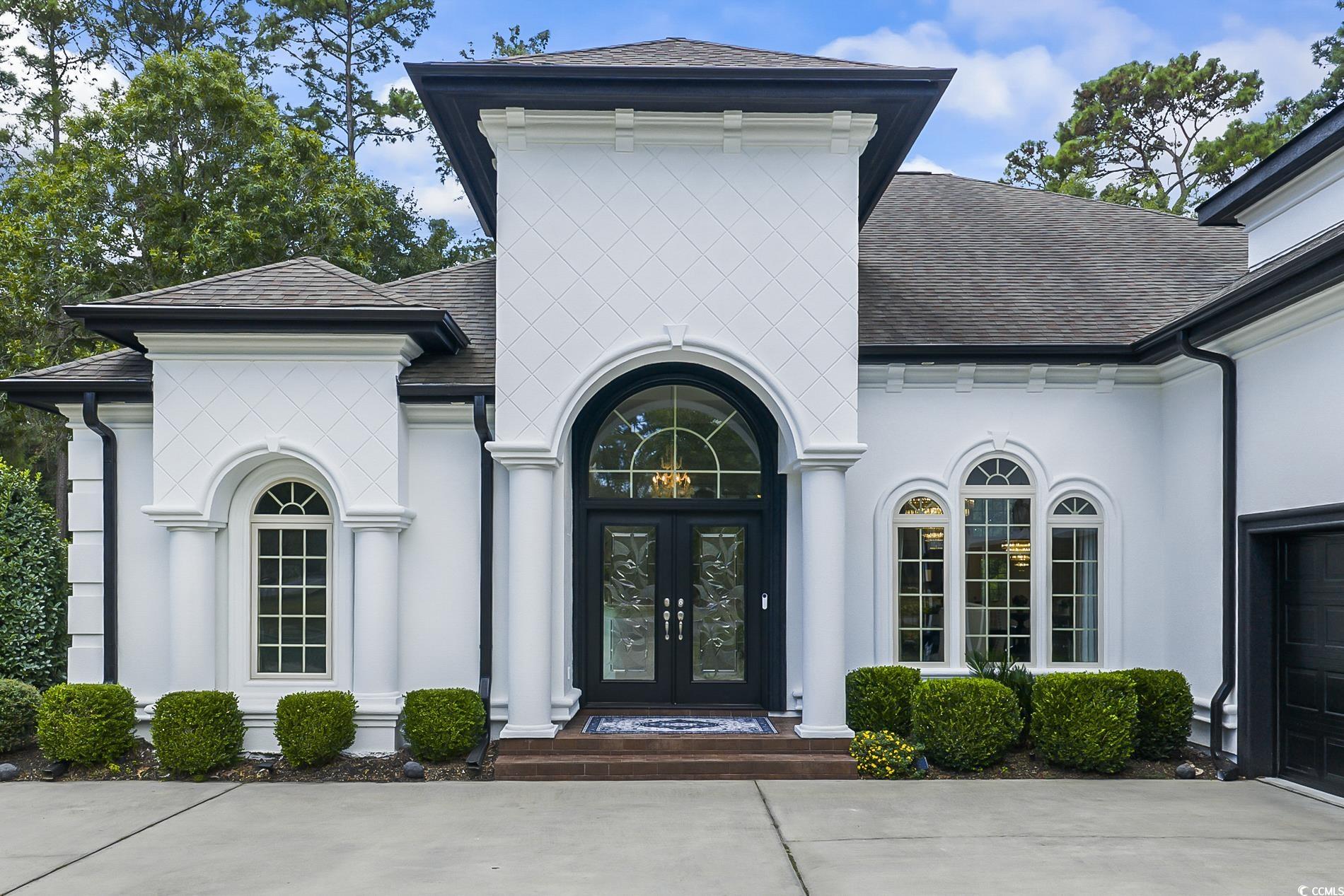 4000 Girvan Drive Myrtle Beach, SC 29579 - Photo 2 of 40 View of exterior entry with a shingled roof, stucco siding, french doors, and an attached garage