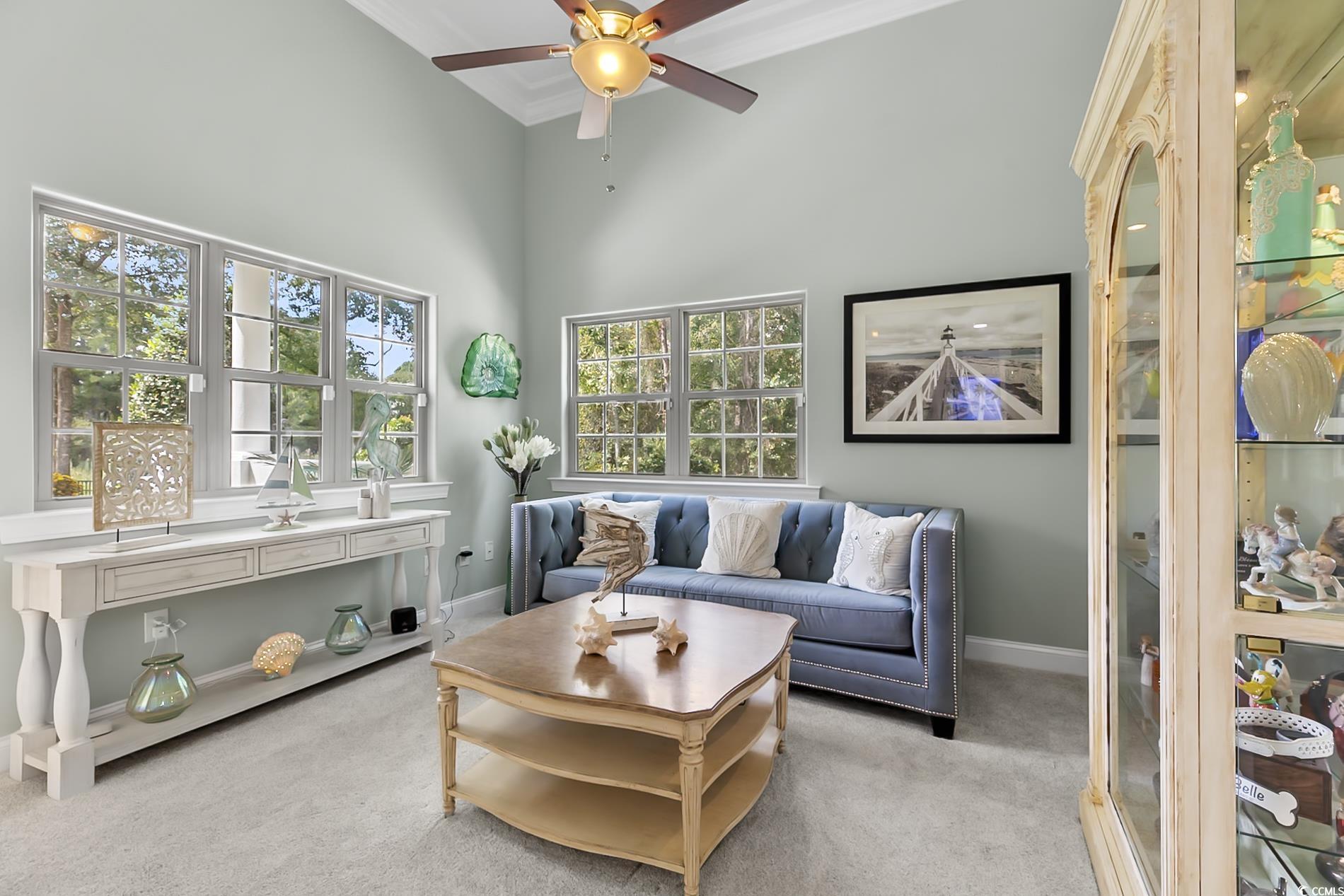 4000 Girvan Drive Myrtle Beach, SC 29579 - Photo 21 of 40 Living room with carpet flooring, a towering ceiling, ornamental molding, and ceiling fan