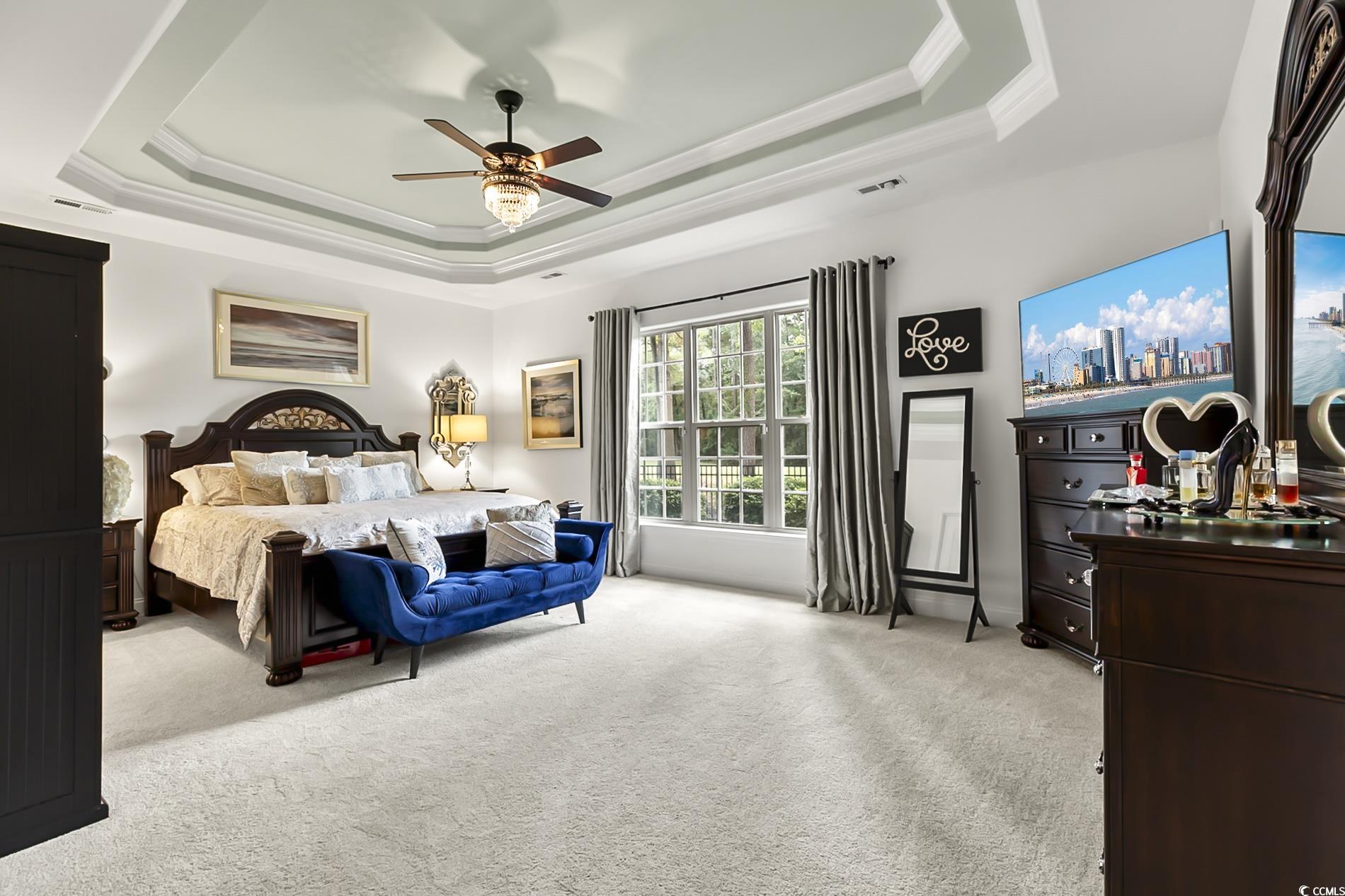 4000 Girvan Drive Myrtle Beach, SC 29579 - Photo 22 of 40 Bedroom featuring a raised ceiling, light carpet, ornamental molding, and ceiling fan