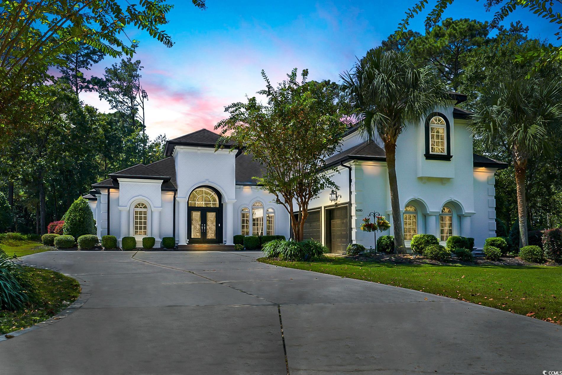 4000 Girvan Drive Myrtle Beach, SC 29579 - Photo 3 of 40 Mediterranean / spanish-style home featuring french doors, stucco siding, curved driveway, and a garage
