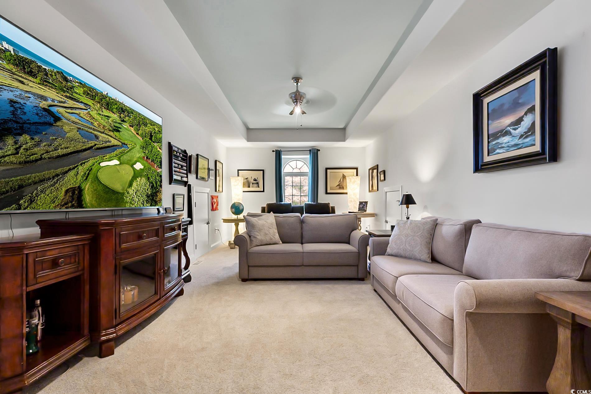 4000 Girvan Drive Myrtle Beach, SC 29579 - Photo 30 of 40 Living area featuring light colored carpet and a raised ceiling