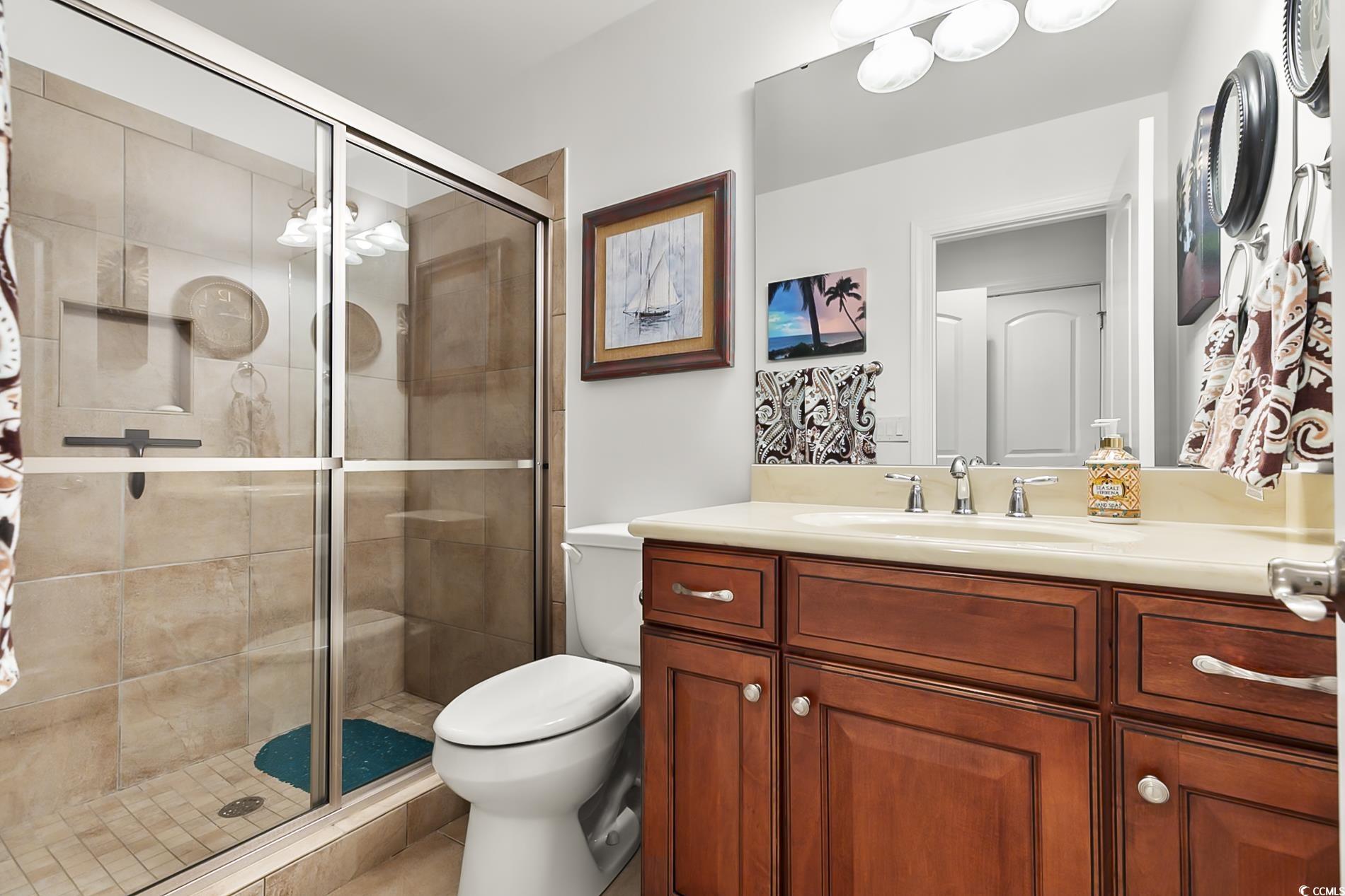 4000 Girvan Drive Myrtle Beach, SC 29579 - Photo 31 of 40 Full bathroom featuring a shower stall and vanity