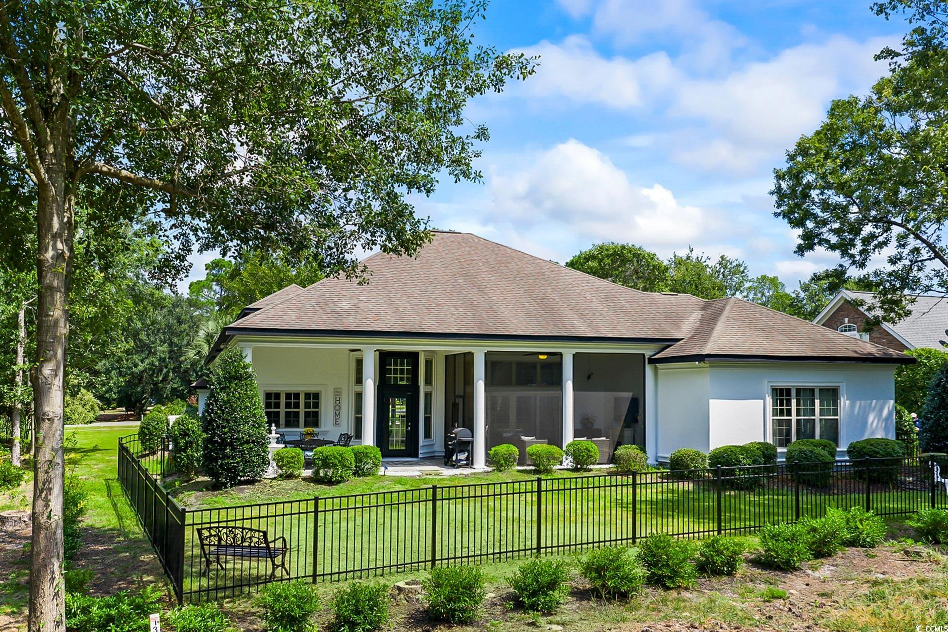 4000 Girvan Drive Myrtle Beach, SC 29579 - Photo 35 of 40 Rear view of property featuring a fenced front yard, roof with shingles, a patio area, and stucco siding