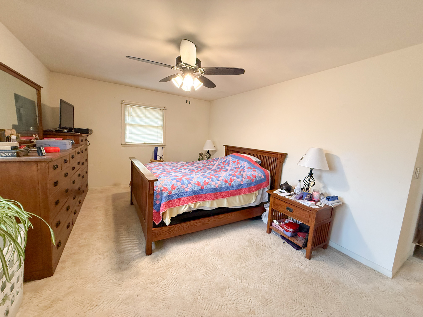 802 East 19th Street Sterling, IL 61081 - Photo 16 of 29 a bedroom with a bed and a chandelier