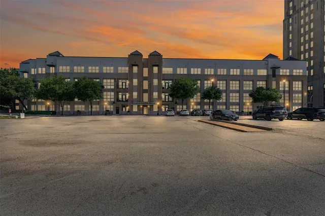 a city street lined with buildings and cars parked in front of it