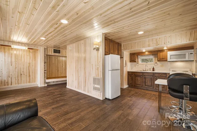 a kitchen with stainless steel appliances kitchen island granite countertop a refrigerator and a stove top oven