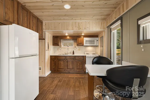 a kitchen with a refrigerator a sink and a stove
