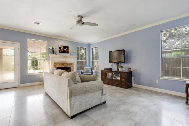 a living room with furniture and a flat screen tv with wooden floor