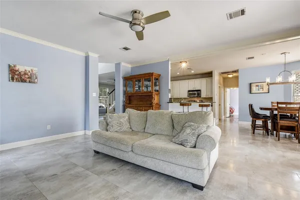 a living room with furniture and kitchen view