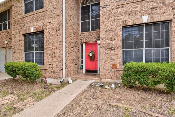 a front view of a brick house with a large windows