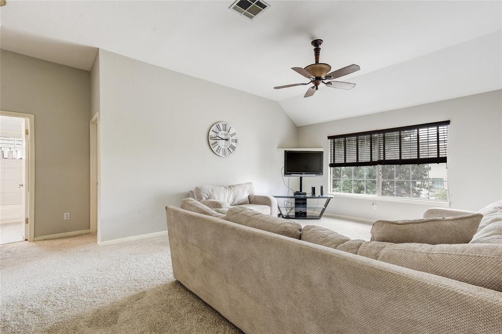 1909 Springwater Drive Round Rock, TX 78681 - Photo 23 of 34 Living room featuring lofted ceiling, carpet, and a ceiling fan