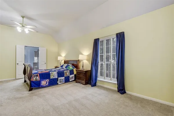 a view of a livingroom with furniture and chandelier fan