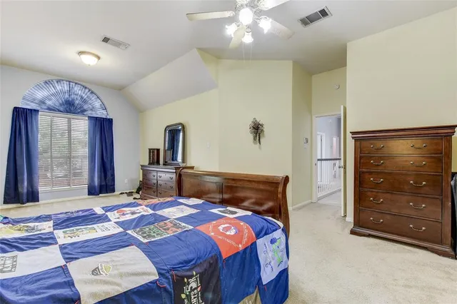 a bedroom with a bed and a dresser