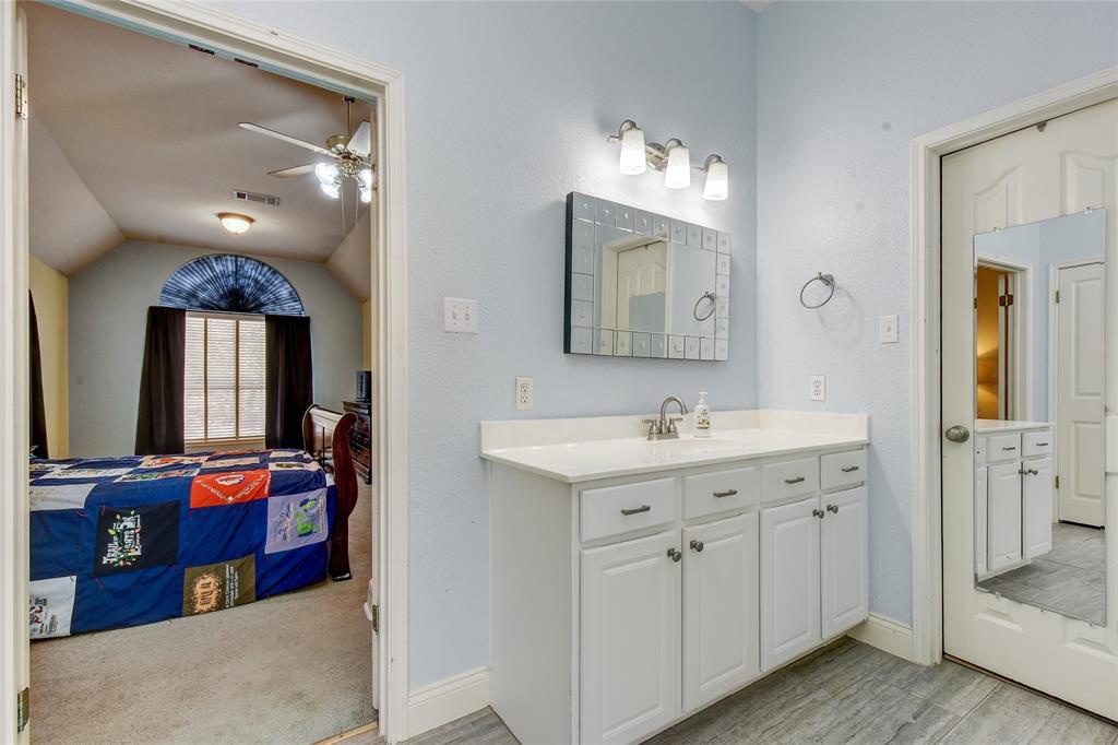 1909 Springwater Drive Round Rock, TX 78681 - Photo 26 of 34 Ensuite bathroom with vanity, a ceiling fan, vaulted ceiling, and light wood-style floors