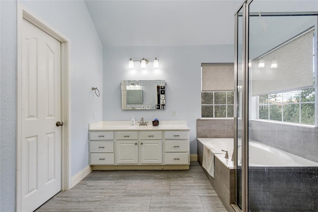 1909 Springwater Drive Round Rock, TX 78681 - Photo 27 of 34 Bathroom featuring a garden tub, vanity, and a stall shower