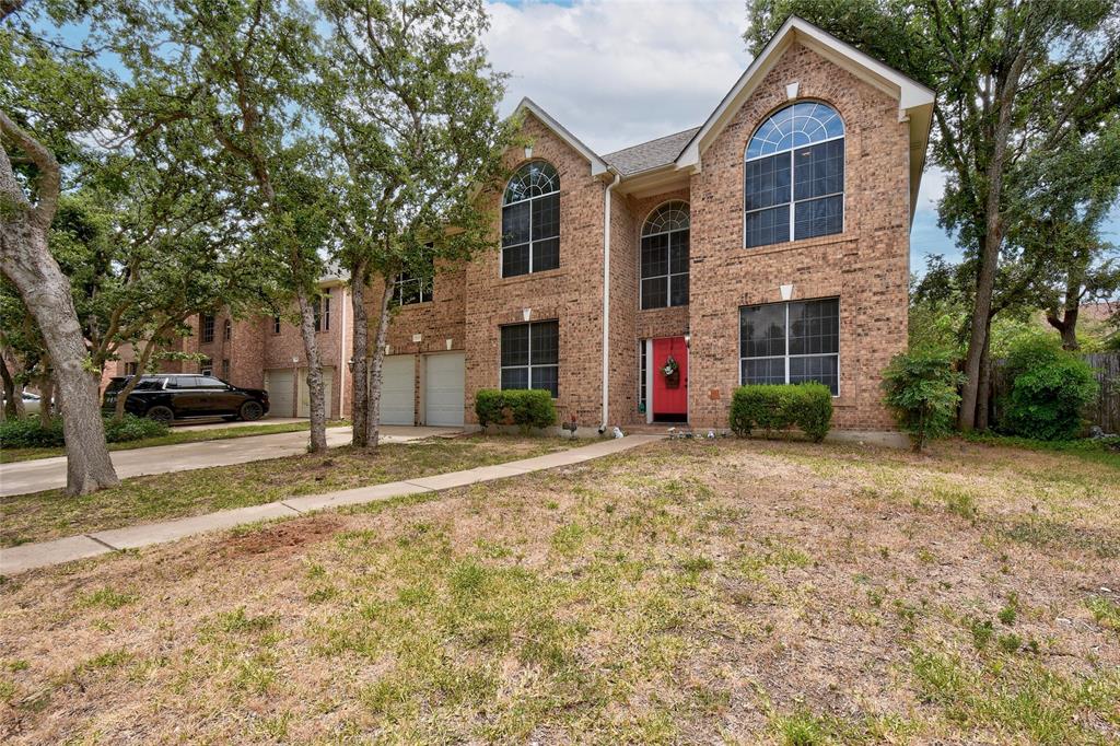 1909 Springwater Drive Round Rock, TX 78681 - Photo 3 of 34 View of front of property featuring brick siding, driveway, a garage, and a front lawn