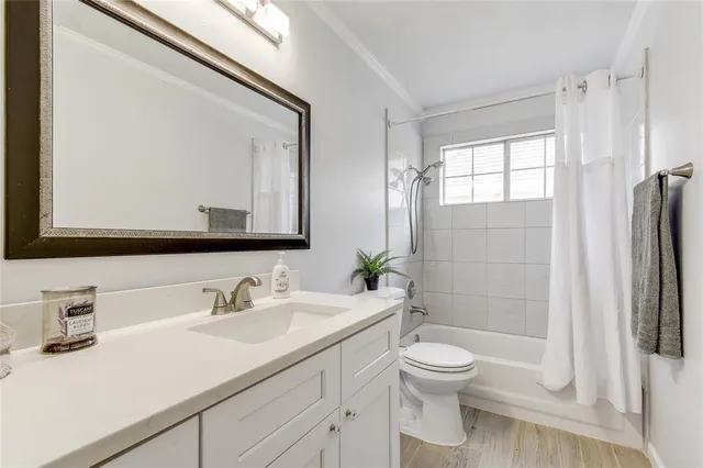 a bathroom with a toilet a sink a tub and mirror