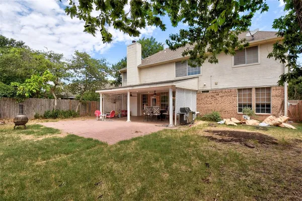 a view of a house with a yard and tree s