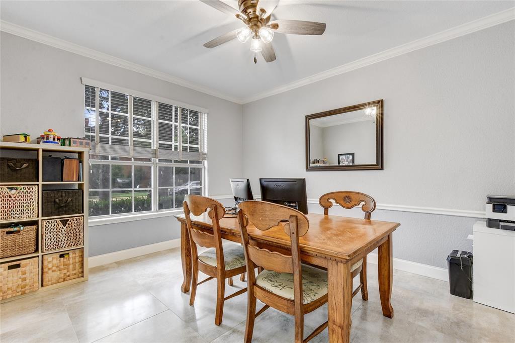 1909 Springwater Drive Round Rock, TX 78681 - Photo 5 of 34 Dining area with a desk, crown molding, and a ceiling fan