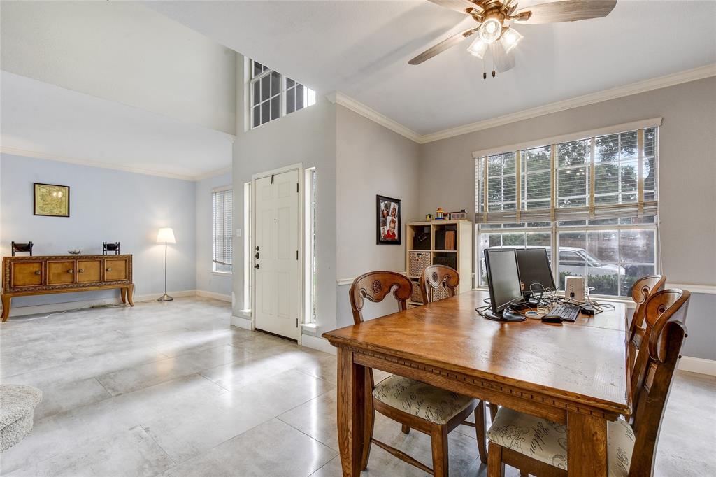 1909 Springwater Drive Round Rock, TX 78681 - Photo 6 of 34 Dining space with ornamental molding, plenty of natural light, ceiling fan, a towering ceiling, and concrete floors