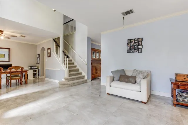 a living room with furniture and a dining table